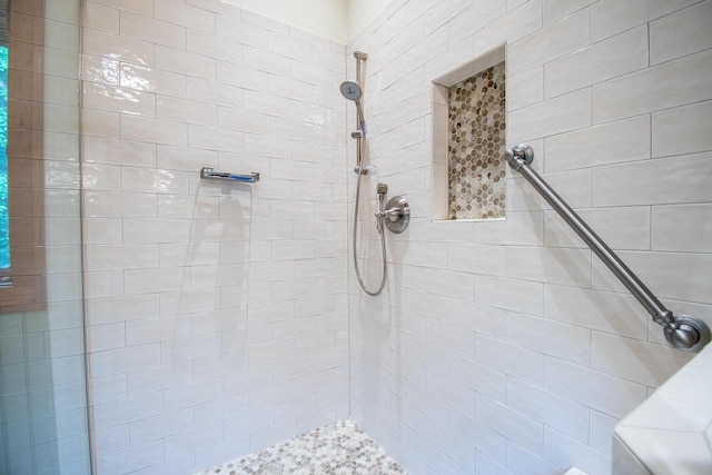 bathroom with tiled shower