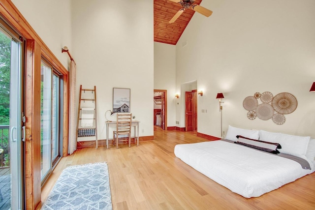 bedroom featuring baseboards, ceiling fan, access to outside, high vaulted ceiling, and wood finished floors