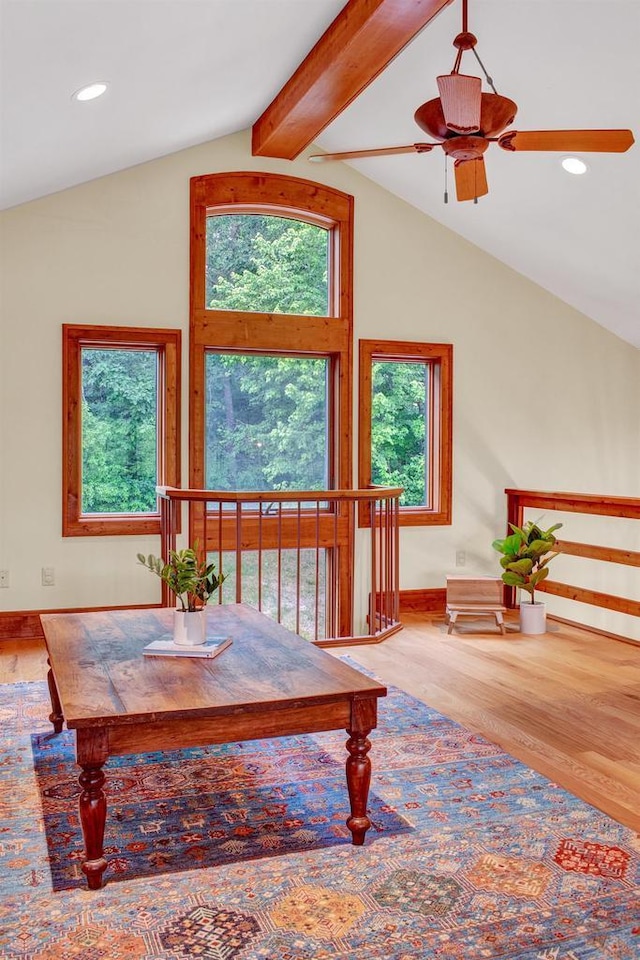 dining room with baseboards, ceiling fan, vaulted ceiling with beams, and wood finished floors