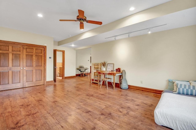 interior space featuring track lighting, wood finished floors, baseboards, and recessed lighting
