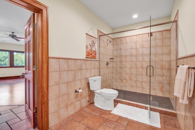 full bathroom with toilet, tile walls, recessed lighting, a stall shower, and ceiling fan