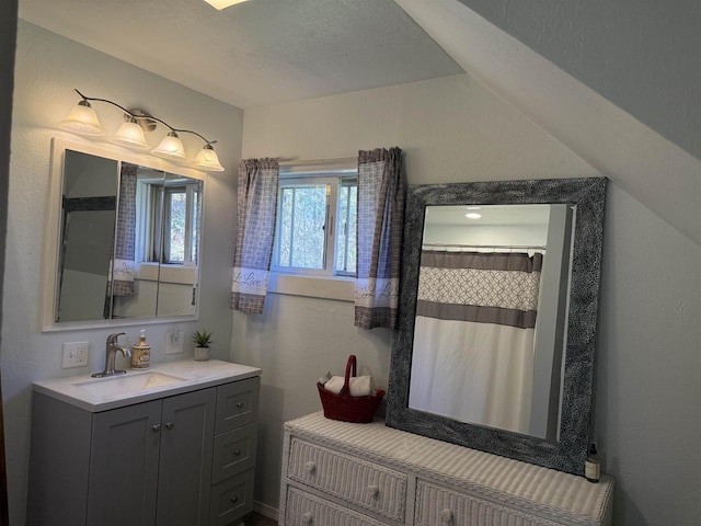 bathroom featuring curtained shower and vanity