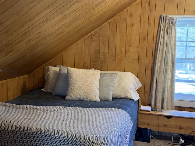 bedroom with lofted ceiling and wood walls
