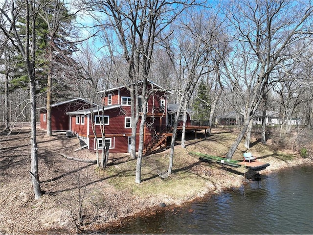 view of property exterior with a deck with water view