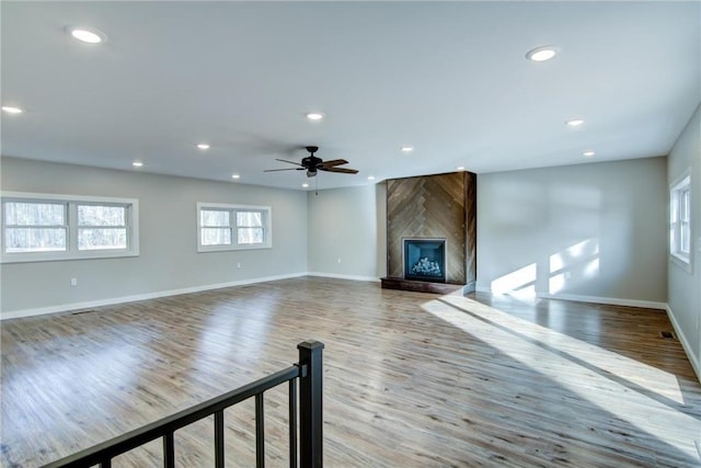 unfurnished living room with baseboards, recessed lighting, a ceiling fan, and wood finished floors