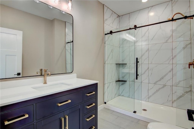 full bath with vanity, toilet, and a shower stall