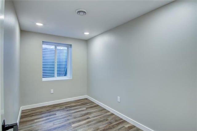 unfurnished room featuring recessed lighting, baseboards, visible vents, and wood finished floors