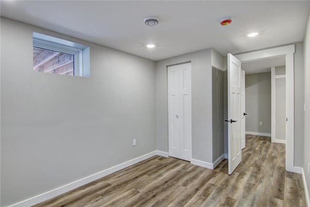 below grade area with baseboards, recessed lighting, and wood finished floors
