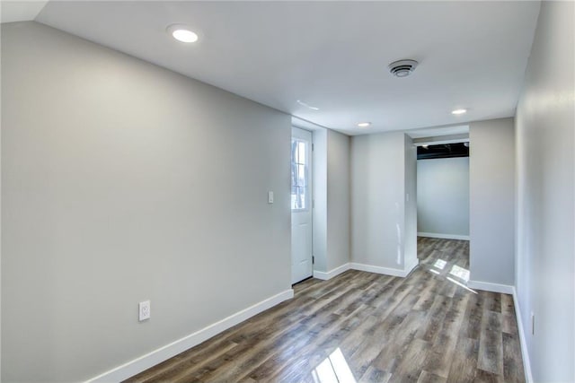 spare room featuring recessed lighting, baseboards, and wood finished floors