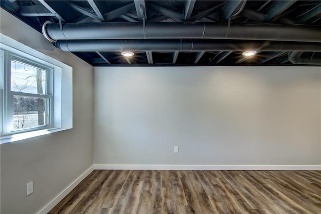 basement with wood finished floors and baseboards