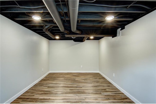 finished basement featuring baseboards and wood finished floors