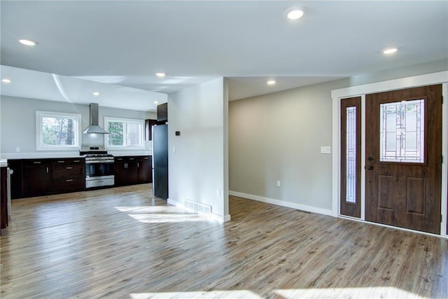 foyer with light wood-style flooring, baseboards, visible vents, and recessed lighting