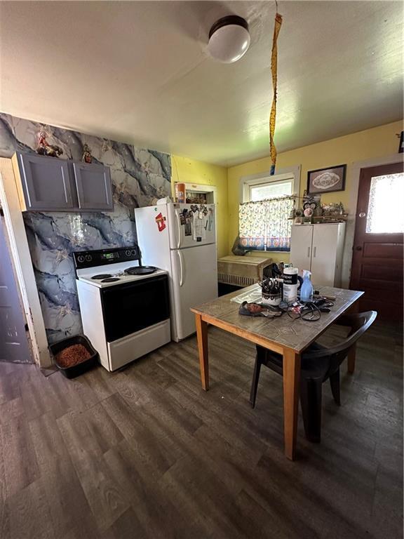 kitchen featuring dark wood-style flooring and white appliances