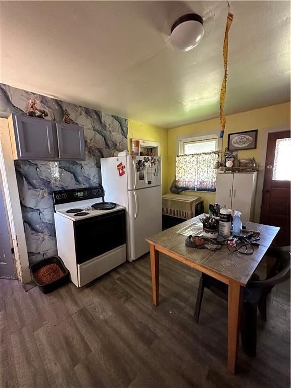 kitchen with dark wood-style flooring and white appliances