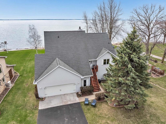 3280 County Rd S, Little Suamico, WI 54141 - view of front facade with roof with shingles, stairs, an attached garage, driveway, and a water view