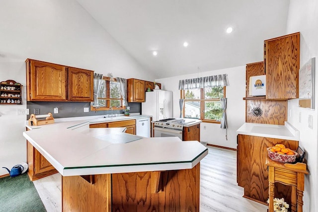 3280 County Rd S, Little Suamico, WI 54141 - kitchen featuring a sink, brown cabinetry, white appliances, high vaulted ceiling, and light countertops