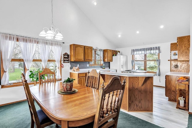 3280 County Rd S, Little Suamico, WI 54141 - dining room featuring light wood-style floors, a chandelier, high vaulted ceiling, and recessed lighting