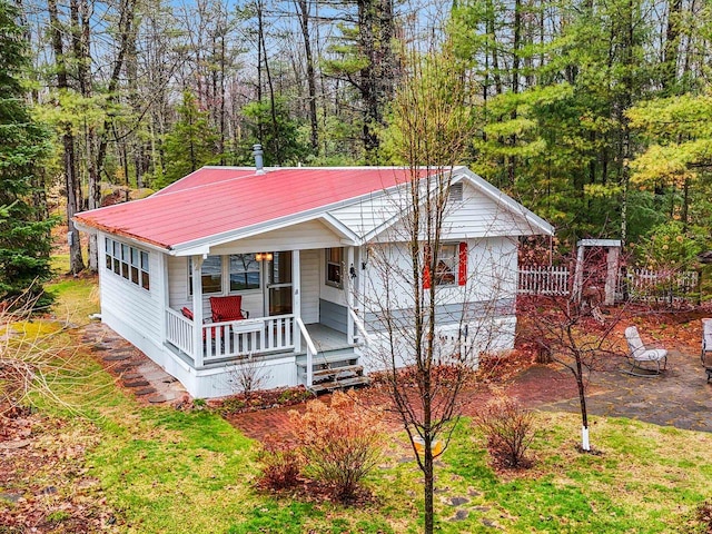 ranch-style home with metal roof and covered porch