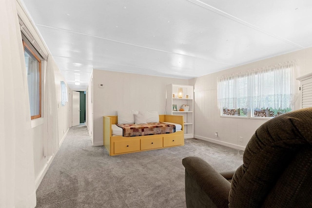 carpeted living area featuring baseboards