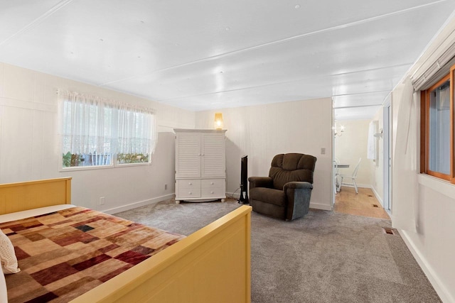 carpeted bedroom featuring baseboards and visible vents