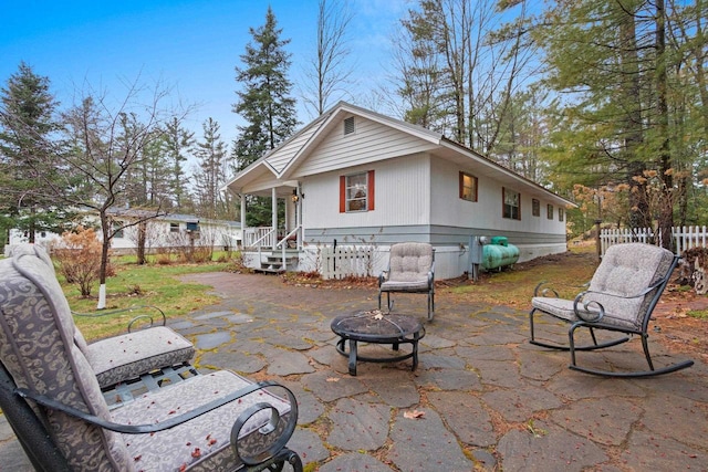 back of house featuring a fire pit, a patio, crawl space, and fence