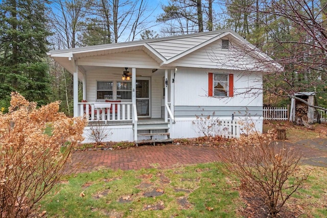 view of front of house with a porch, fence, and a ceiling fan