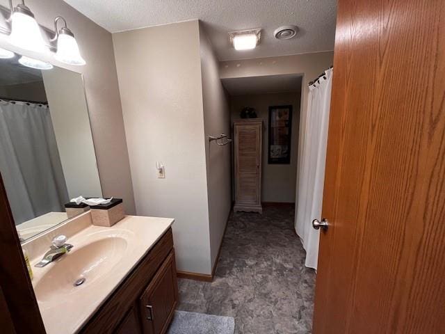 3403 Lever St Unit B, Eau Claire, WI 54701 - bathroom featuring a textured ceiling, visible vents, baseboards, and vanity