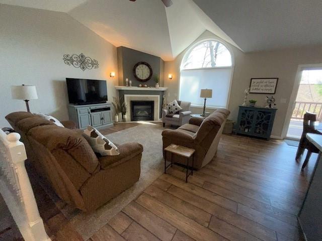 3403 Lever St Unit B, Eau Claire, WI 54701 - living area featuring vaulted ceiling, a fireplace, wood-type flooring, and a ceiling fan