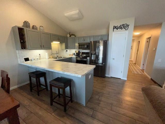 3403 Lever St Unit B, Eau Claire, WI 54701 - kitchen with a peninsula, a sink, stainless steel appliances, dark wood finished floors, and gray cabinets