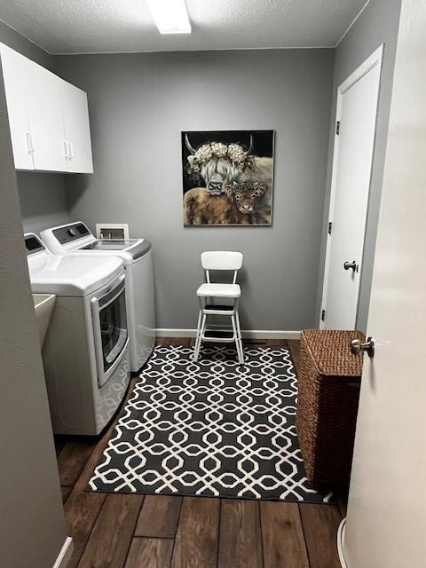 3403 Lever St Unit B, Eau Claire, WI 54701 - clothes washing area featuring washing machine and dryer, cabinet space, baseboards, and wood finished floors