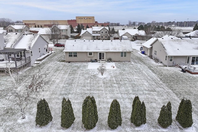 snowy aerial view featuring a residential view