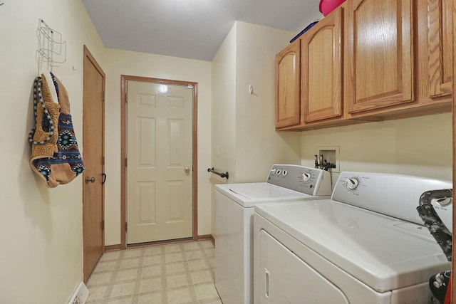 clothes washing area featuring baseboards, light floors, separate washer and dryer, and cabinet space
