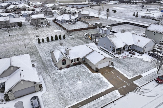 snowy aerial view with a residential view