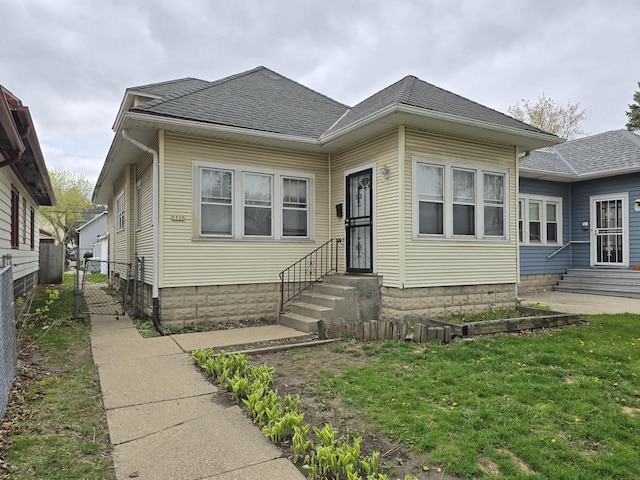 5535 N 40th St, Milwaukee, WI 53209 - bungalow-style house featuring entry steps, a shingled roof, and fence