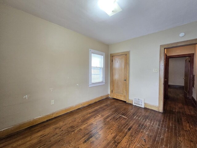 5535 N 40th St, Milwaukee, WI 53209 - unfurnished bedroom featuring baseboards, visible vents, and dark wood-style floors