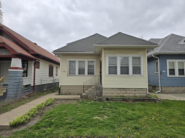 5535 N 40th St, Milwaukee, WI 53209 - back of property with a yard, roof with shingles, entry steps, and fence