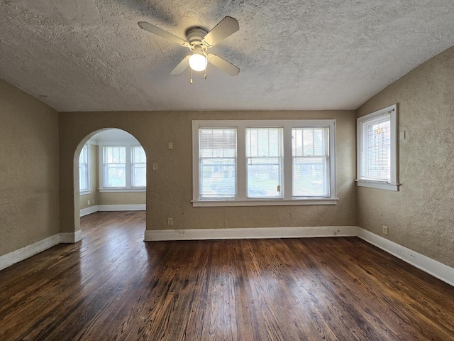 5535 N 40th St, Milwaukee, WI 53209 - unfurnished room with arched walkways, dark wood finished floors, ceiling fan, and a textured ceiling