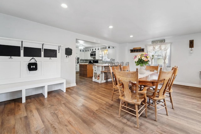 dining space with baseboards, light wood-style floors, and recessed lighting