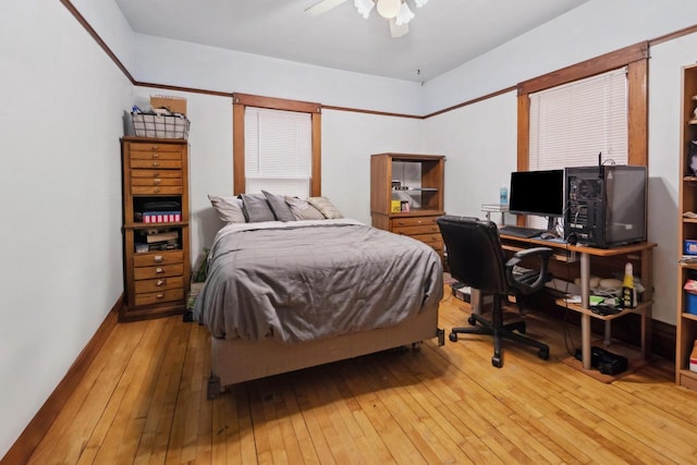 bedroom with light wood finished floors and a ceiling fan