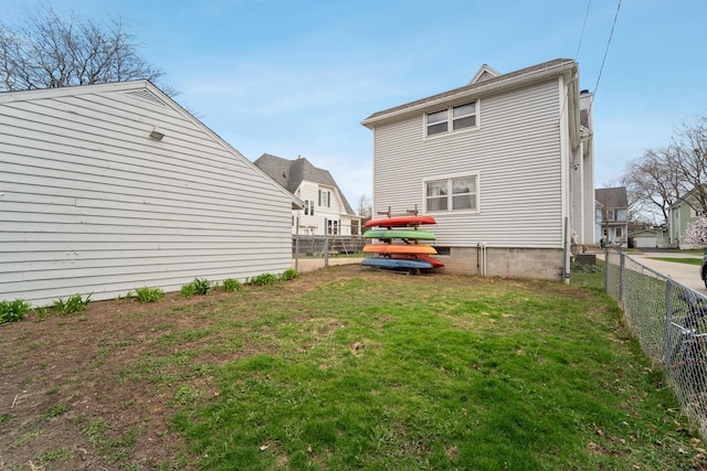 back of property with a lawn and a fenced backyard