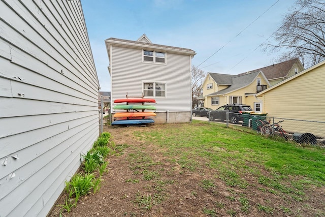 rear view of property featuring fence