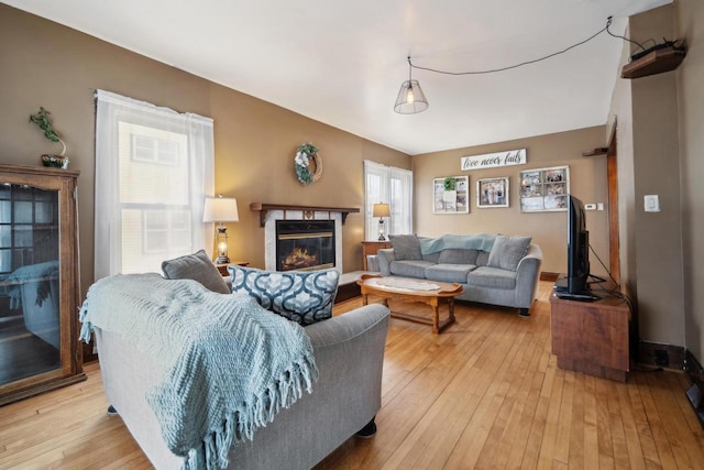 living room with a fireplace and light wood finished floors