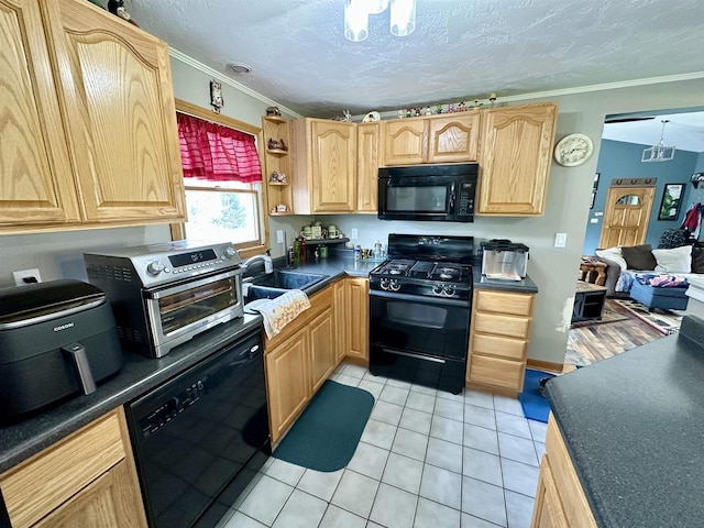 kitchen featuring a toaster, light tile patterned floors, ornamental molding, a sink, and black appliances