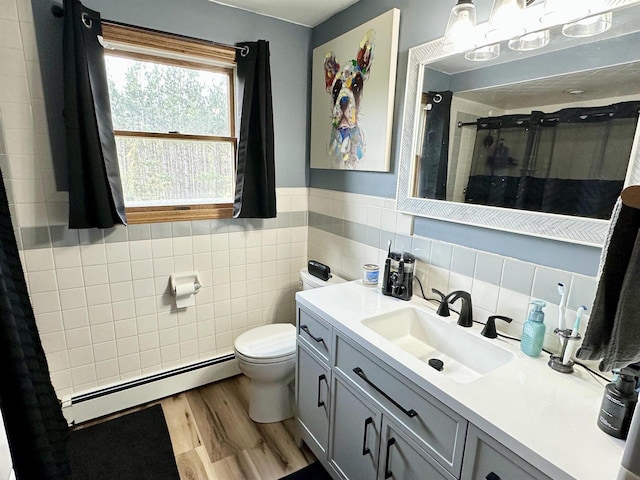 full bath with tile walls, a baseboard heating unit, toilet, curtained shower, and wood finished floors