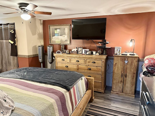 bedroom featuring ceiling fan and wood finished floors