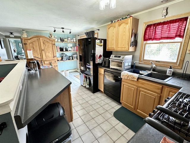 kitchen featuring light tile patterned floors, a sink, dark countertops, black appliances, and ornamental molding