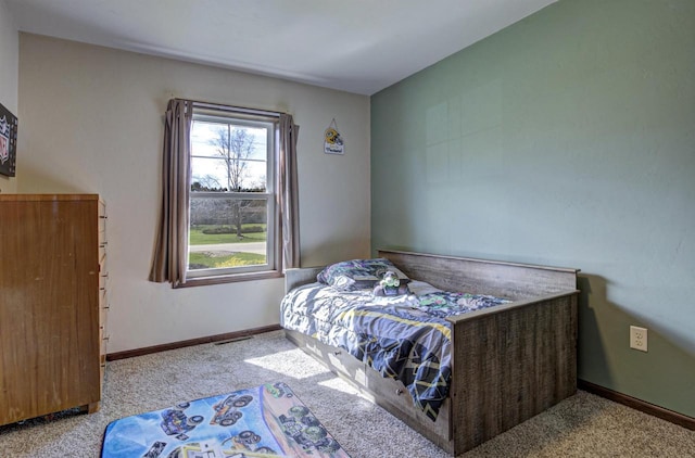 bedroom featuring baseboards, visible vents, and carpet