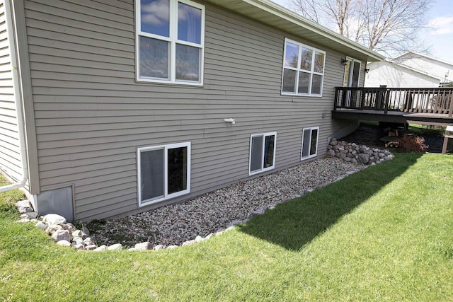 rear view of house with a yard and a deck