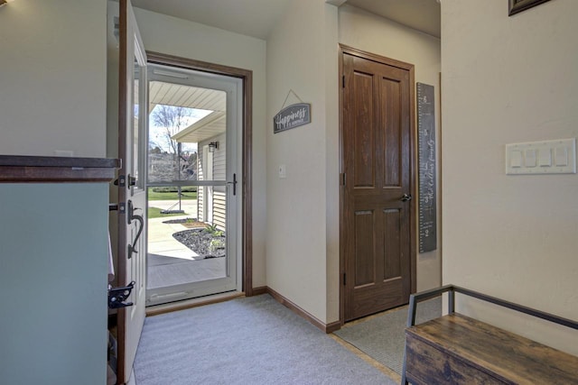 entryway featuring carpet and baseboards