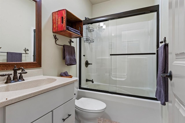 full bathroom featuring bath / shower combo with glass door, vanity, and toilet